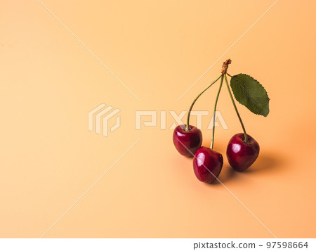Cherry on yellow creamy background, copy space 97598664