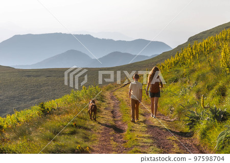 Happy Family with Child and Dog Hiking in Mountains Happy Family with Child and Dog Hiking in Mountains 97598704