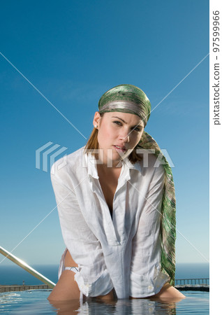 attractive woman in the sun in a seaside area in good weather 97599966