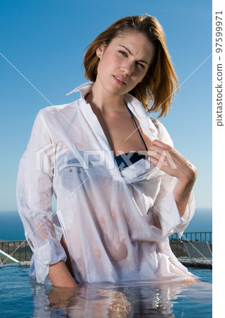 attractive woman in the sun in a seaside area in good weather 97599971
