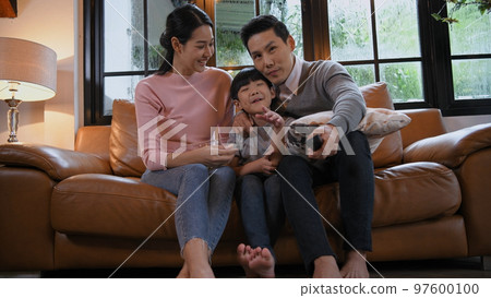 Family concept of 4k Resolution. Asian parents and children watching movies together at home on vacation. 97600100