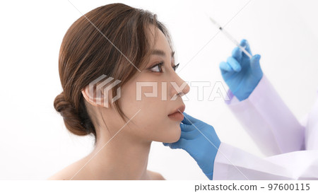 Beauty concept of 4k Resolution. Asian woman getting injection on face on white background. 97600115