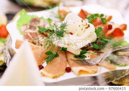 plate of appetizer of salmon on the table in the restaurant 97600415