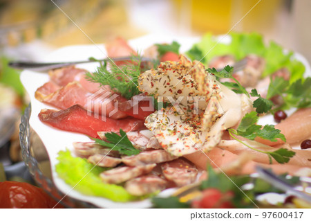 plate with meat appetizer on the table in the restaurant plate with meat appetizer on the table in the restaurant 97600417