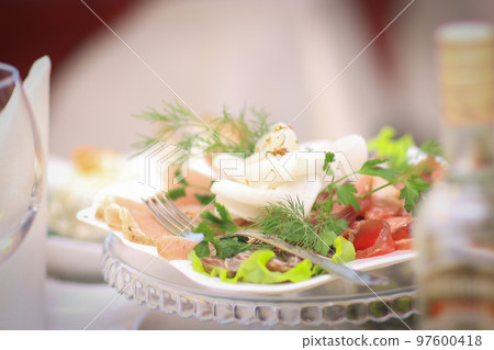 plate with meat appetizer on the table in the restaurant plate with meat appetizer on the table in the restaurant 97600418