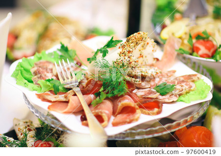 plate with meat appetizer on the table in the restaurant plate with meat appetizer on the table in the restaurant 97600419