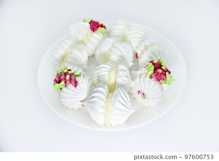 Delicious bizet marshmallows on a white plate. A sweet snack. Marshmallows for tea. 97600753