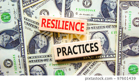Resilience practices symbol. Concept word Resilience practices typed wooden blocks. Beautiful background from dollar bills. Business and resilience practices concept. Copy space. 97601439