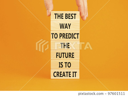 Create future symbol. Concept words The best way to predict the future is to create it on wooden blocks. Beautiful orange background copy space. Businessman hand. Business create your future concept. Create future symbol. Concept words The best way to predict the future is to create it on wooden blocks. Beautiful orange background copy space. Businessman hand. Business create your future concept. 97601511