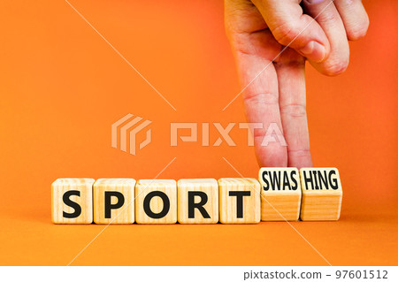 Sport or sportswashing symbol. Concept words Sport and Sportswashing on wooden cubes. Businessman hand. Beautiful orange table orange background. Business sport sportswashing concept. Copy space. Sport or sportswashing symbol. Concept words Sport and Sportswashing on wooden cubes. Businessman hand. Beautiful orange table orange background. Business sport sportswashing concept. Copy space. 97601512