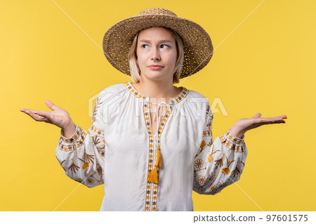 Confused ukrainian woman, shoulders up - can't help, makes gesture of I dont know. Difficult 97601575