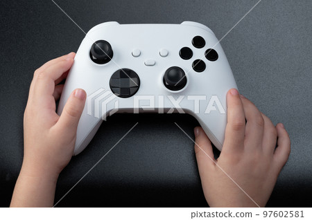 Wireless game controller in kid hand 97602581
