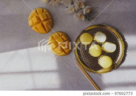 Tasty dessert Mochi with mango fruit on grey background Tasty dessert Mochi with mango fruit on grey background 97602773