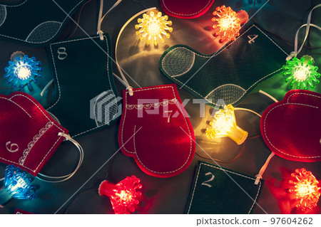Felt stockings, mittens and fairy lights as beautiful Christmas home decoration. Advent calendar for kids 97604262