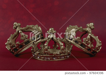 Happy Three King's Day. Three gold crowns on red background. Concept for Reyes Magos, Three Wise Men or Happy Epiphany day. 97604396