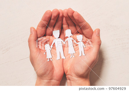 Hands with paper family silhouette. Family care 97604929