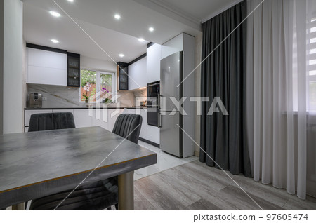 New large modern well designed white kitchen and dining room in studio flat interior 97605474