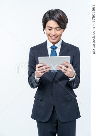 businessman operating a tablet 97605668