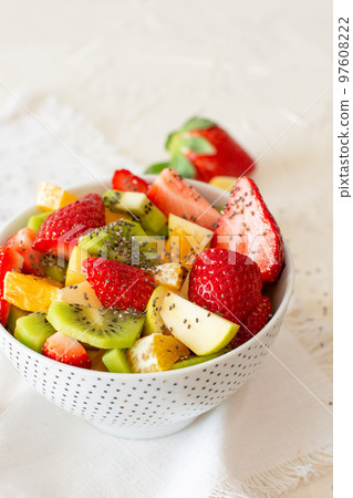 Bowl of healthy fresh fruit salad on white background. Top view Bowl of healthy fresh fruit salad on white background. Top view 97608222