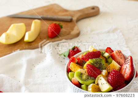 Bowl of healthy fresh fruit salad on white background. Top view Bowl of healthy fresh fruit salad on white background. Top view 97608223