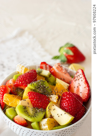 Bowl of healthy fresh fruit salad on white background. Top view Bowl of healthy fresh fruit salad on white background. Top view 97608224