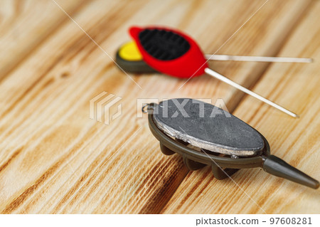 Lead sinker on wooden background macro shot 97608281