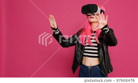 Modern stylish girl using vr glasses with augmented reality tech, futuristic interactive wireless headset. Young pretty adult having fun with simulator and 3d innovation, electronic system. Modern stylish girl using vr glasses with augmented reality tech, futuristic interactive wireless headset. Young pretty adult having fun with simulator and 3d innovation, electronic system. 97608476