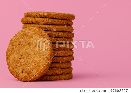 Stack of round oat cookies on paper background 97608537