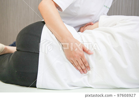 A woman undergoing waist surgery 97608927