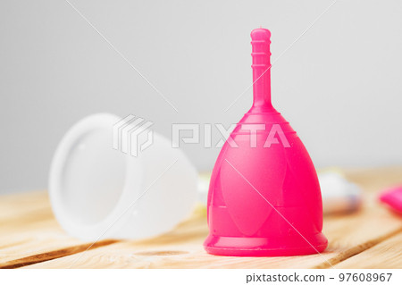Two menstrual cups on table close up Two menstrual cups on table close up 97608967