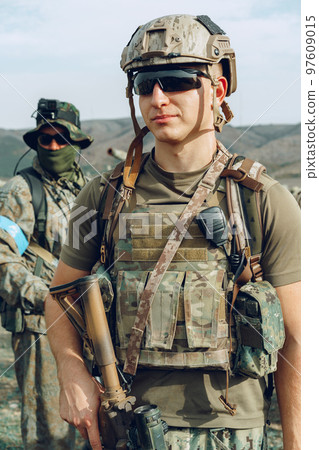 Soldier standing on polygon during military training 97609015