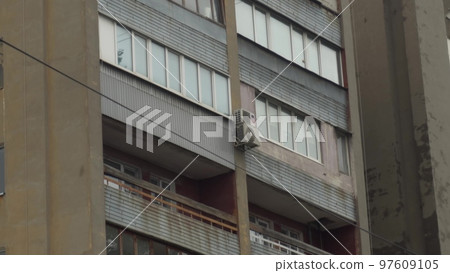 Dilapidated post-Soviet building close-up. A dilapidated tenement building with balconies. Shooting from top to bottom. Dilapidated post-Soviet building close-up. A dilapidated tenement building with balconies. Shooting from top to bottom. 97609105