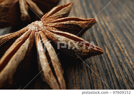 Macro photo of anise stars on wooden background Macro photo of anise stars on wooden background 97609152
