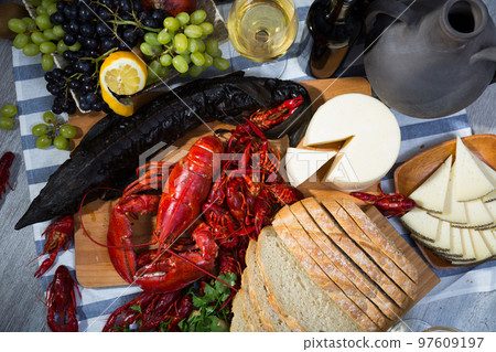 Top view of smoked sturgeon, crustaceans, fruits and wine 97609197