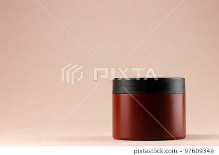 Brown plain cosmetic package on beige background Brown plain cosmetic package on beige background 97609349