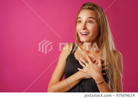 Peaceful young blonde woman holding hands on her chest. Peaceful young blonde woman holding hands on her chest. 97609624