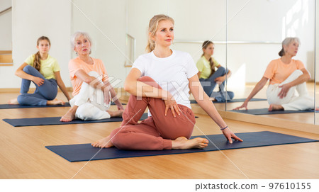 Woman doing stretching workout Woman doing stretching workout 97610155