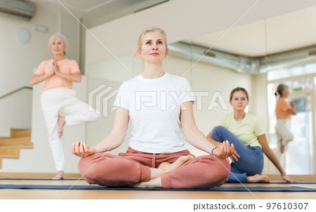 Woman practice yoga lotus pose 97610307