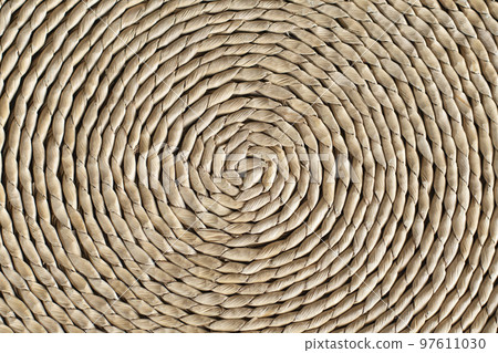 Handcrafted mat pattern made by twisting dried leaves Handcrafted mat pattern made by twisting dried leaves 97611030