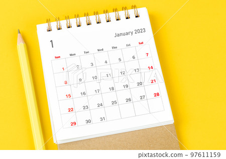 A September 2023 Monthly desk calendar for 2023 with pencil on yellow background. 97611159