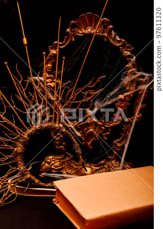 Halloween book composition, spider web, old vintage frame on a black background 97611320