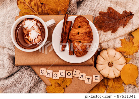 Autumn composition book, croissant, coffee, leaves and pumpkin Autumn composition book, croissant, coffee, leaves and pumpkin 97611341