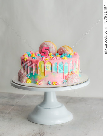 pink 5th anniversary birthday frosted icing dripping cake on white background pink 5th anniversary birthday frosted icing dripping cake on white background 97611494