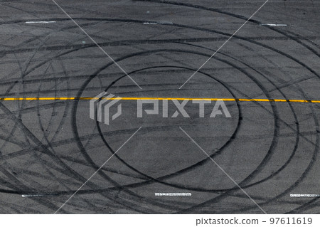 Tire track mark on asphalt tarmac road race track texture and background, Abstract background black tire tracks skid on asphalt road in racing circuit, Tire mark skid mark on asphalt road. 97611619
