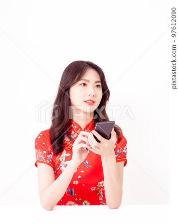 traditional cheongsam using smart phone isolated on white background 97612090