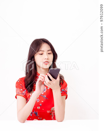 traditional cheongsam using smart phone isolated on white background traditional cheongsam using smart phone isolated on white background 97612099