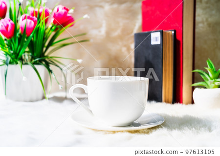 Coffee cup with book stacked on table Coffee cup with book stacked on table 97613105