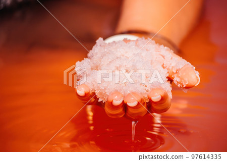 Young woman with long hair in pink salty lake with crystals of salt. Extremely salty pink lake, colored by microalgae with crystalline salt depositions. Spa, beauty and health care concept. Young woman with long hair in pink salty lake with crystals of salt. Extremely salty pink lake, colored by microalgae with crystalline salt depositions. Spa, beauty and health care concept. 97614335