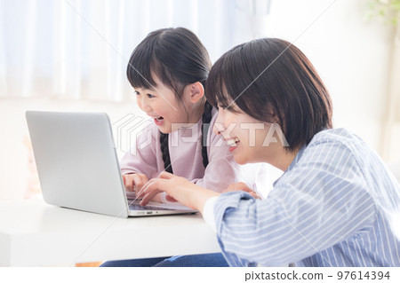 Family mom and girl looking at a computer 97614394