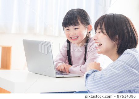Family mom and girl looking at a computer 97614396